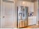 Stainless steel refrigerator in a kitchen with white cabinets at 277 Hamptons Cove Rd, Troutman, NC 28166