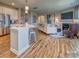 Open concept kitchen and living room with island and fireplace at 277 Hamptons Cove Rd, Troutman, NC 28166