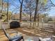 Outdoor deck area with grill, seating, and a view of mature trees, perfect for relaxing or entertaining guests at 294 Carroll Cv, Clover, SC 29710