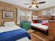 Bedroom with wood paneling featuring a twin bed, bunk bed, and hardwood floors at 294 Carroll Cv, Clover, SC 29710
