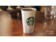 A steaming cup of Starbucks Coffee sits on a reflective brown table at 294 Carroll Cv, Clover, SC 29710