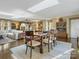 Inviting dining room features a large table set on a decorative rug, skylights and hardwood floors at 294 Carroll Cv, Clover, SC 29710