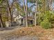 Charming cottage exterior surrounded by mature trees in a natural setting, complete with a cozy front porch at 294 Carroll Cv, Clover, SC 29710
