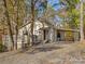 Charming home exterior with a deck, carport, and rustic details, nestled among mature trees at 294 Carroll Cv, Clover, SC 29710