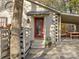 Inviting front entrance with a decorative wreath on the red door and a charming bell, with covered parking nearby at 294 Carroll Cv, Clover, SC 29710