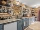 Rustic kitchen boasts unique wood walls, granite countertops, and open shelving for a farmhouse-chic aesthetic at 294 Carroll Cv, Clover, SC 29710