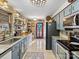 Rustic kitchen with blue cabinets, granite countertops, and wood paneled walls at 294 Carroll Cv, Clover, SC 29710