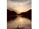 A stunning sunset over a calm lake viewed from a kayak, showcasing vibrant colors and a serene atmosphere at 294 Carroll Cv, Clover, SC 29710