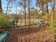 Spacious, leaf-covered property with waterfront access, featuring seating and a small dock on the calm lake at 294 Carroll Cv, Clover, SC 29710