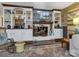 Living room featuring shelves, fireplace, TV, and hardwood floors with an area rug at 294 Carroll Cv, Clover, SC 29710