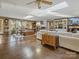 Open-concept living area includes dining and living spaces, skylights, hardwood floors, and fireplace at 294 Carroll Cv, Clover, SC 29710