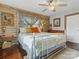 Charming main bedroom featuring wood paneling, unique decor, ceiling fan, and a comfortable bed at 294 Carroll Cv, Clover, SC 29710