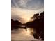 Water view featuring sunset over a calm river with a person kayaking and trees in the background at 294 Carroll Cv, Clover, SC 29710