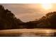 Scenic water view featuring a bridge beneath a radiant sunrise, framed by lush trees at 294 Carroll Cv, Clover, SC 29710