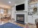 Living room with fireplace, built-in shelving, and a view of the dining area at 884 Park Slope Dr, Charlotte, NC 28209