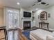 Living room with fireplace, hardwood floors, and comfy seating at 884 Park Slope Dr, Charlotte, NC 28209