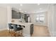 Open concept kitchen and dining area with gray cabinets and hardwood floors at 1094 Herrons Ferry Rd, Rock Hill, SC 29730