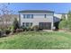 Manicured backyard showcasing a well-maintained lawn, charming screened patio, and lush landscaping at 12023 Huntson Reserve Rd, Huntersville, NC 28078