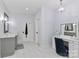 A bathroom with a double vanity, marble floors, toilet, and a makeup vanity with a chair at 12023 Huntson Reserve Rd, Huntersville, NC 28078