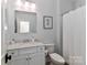 Bright bathroom with a sink, granite vanity, toilet, and a shower with a curtain at 12023 Huntson Reserve Rd, Huntersville, NC 28078