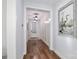 Hallway featuring hardwood floors, white trim, and a decorative painting adding a touch of elegance at 12023 Huntson Reserve Rd, Huntersville, NC 28078