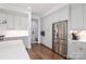 A bright kitchen showcases stainless steel appliances, white cabinetry, and hardwood floors at 12023 Huntson Reserve Rd, Huntersville, NC 28078