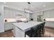 Modern kitchen with stainless steel appliances, a large island with seating, and bright lighting at 12023 Huntson Reserve Rd, Huntersville, NC 28078