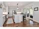 Modern white kitchen with stainless steel appliances, a kitchen island, and sliding glass doors at 12023 Huntson Reserve Rd, Huntersville, NC 28078