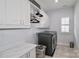 A tidy laundry room with a washer, dryer, laundry sink, cabinets, and a marble counter at 12023 Huntson Reserve Rd, Huntersville, NC 28078