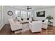 Bright and airy living room with hardwood floors, white couches, plantation shutters, and a large clock at 12023 Huntson Reserve Rd, Huntersville, NC 28078