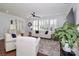 Comfortable living room with hardwood floors, large windows with plantation shutters, and cozy white furniture at 12023 Huntson Reserve Rd, Huntersville, NC 28078