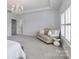 Bright main bedroom with a tray ceiling, chandelier, neutral decor, and sitting area at 12023 Huntson Reserve Rd, Huntersville, NC 28078