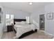 Inviting bedroom with a large bed, bedside tables, shuttered windows, and ensuite bathroom at 12023 Huntson Reserve Rd, Huntersville, NC 28078