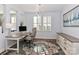 Bright home office with shutters, a modern desk, an ergonomic chair, and plenty of natural light at 12023 Huntson Reserve Rd, Huntersville, NC 28078