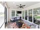 Relaxing screened-in patio with comfortable seating, ceiling fan, and view of the outdoor space at 12023 Huntson Reserve Rd, Huntersville, NC 28078