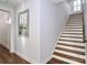 Staircase with hardwood treads and white risers, adding a touch of classic design to the home's interior at 12023 Huntson Reserve Rd, Huntersville, NC 28078