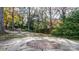 Brick patio nestled in a lush, wooded backyard with a circular design at 1235 10Th Ne St, Hickory, NC 28601