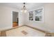 Dining area with tile floor, chandelier, and view of living room at 1235 10Th Ne St, Hickory, NC 28601