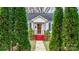 Charming white house with red steps, gray shutters, and well-manicured landscaping at 1235 10Th Ne St, Hickory, NC 28601