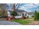 Charming white house with red steps, brick chimney, and landscaping at 1235 10Th Ne St, Hickory, NC 28601