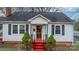 Front view of a white house with red steps and landscaping at 1235 10Th Ne St, Hickory, NC 28601