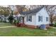 Side view of a white house with red steps and landscaping at 1235 10Th Ne St, Hickory, NC 28601