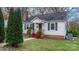 White house with red steps, gray shutters, and a small front yard at 1235 10Th Ne St, Hickory, NC 28601