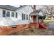 House exterior showcasing the side elevation with red steps and brickwork at 1235 10Th Ne St, Hickory, NC 28601