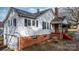 View of the home's exterior, highlighting the white siding and red brick foundation at 1235 10Th Ne St, Hickory, NC 28601