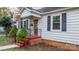 Home's exterior featuring a front porch with red steps and black railings at 1235 10Th Ne St, Hickory, NC 28601