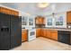 Kitchen with wood cabinets, white appliances, and tile floor at 1235 10Th Ne St, Hickory, NC 28601