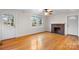 Living room with hardwood floors, fireplace, and two windows at 1235 10Th Ne St, Hickory, NC 28601