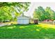 Spacious backyard featuring lush green grass, white storage shed, and car port perfect for outdoor activities at 2005 Robyn Ave, Shelby, NC 28152
