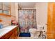 The bathroom has a floral shower curtain, a single vanity, and neutral tile flooring at 2005 Robyn Ave, Shelby, NC 28152